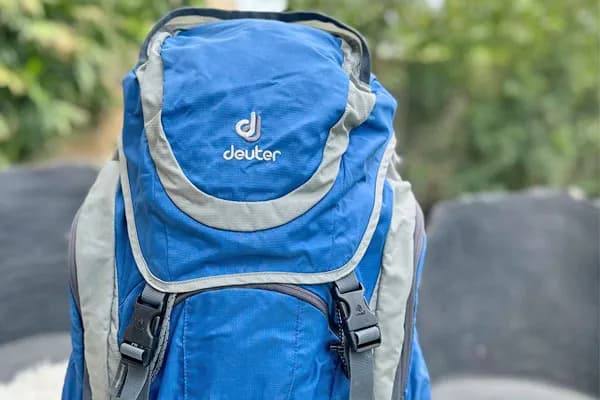 Close-up shot of a blue and grey Deuter trekking backpack packed and ready for a hiking expedition