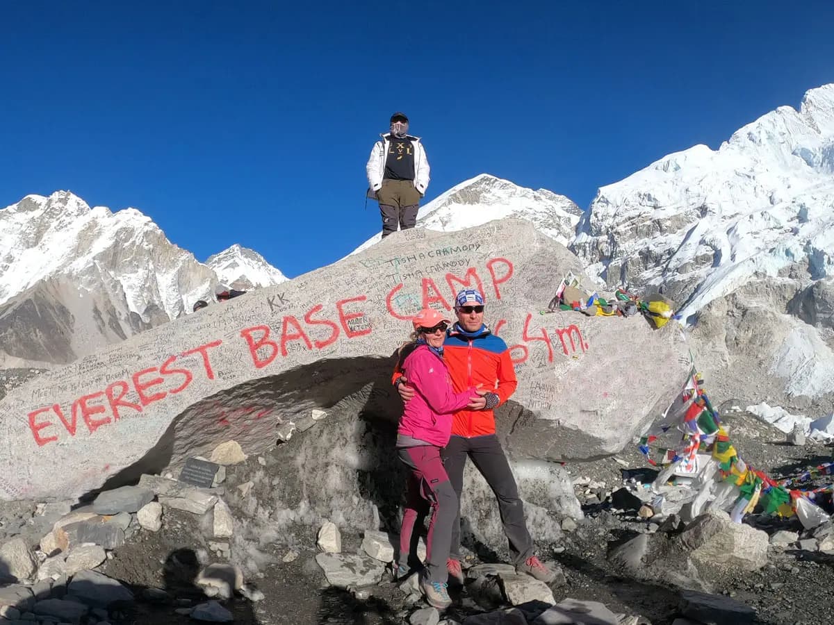 Hikers posing at Everest Base Camp marker