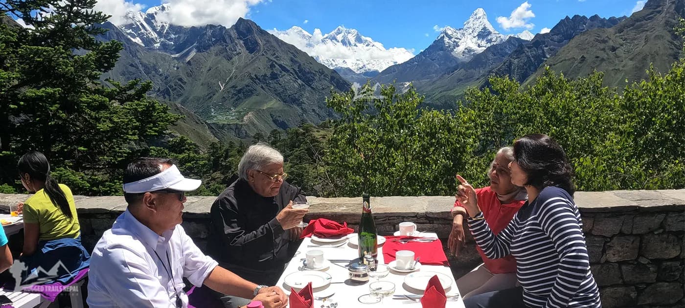 Travelers enjoying breakfast outdoors at Hotel Everest View in Syangboche with panoramic views of Mount Everest and Mt. Ama Dablam