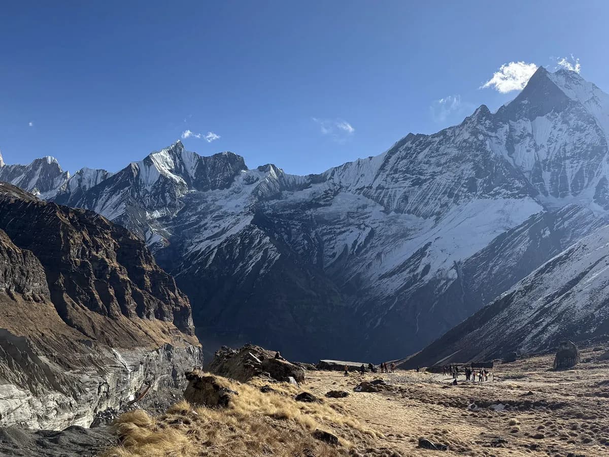 panoramic landscape view of Mount Machhapuchhre and surrounding snow-capped Himalayan mountains.