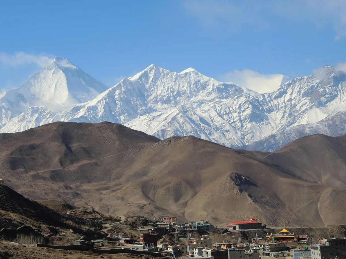 Wide panoramic landscape view of a snow-blanketed mountain valley in Lower Mustang