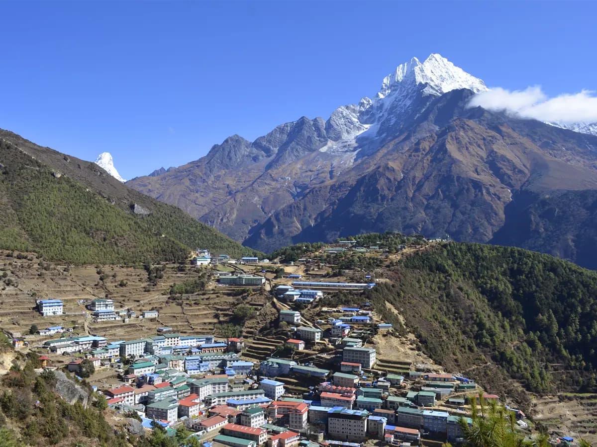 Panoramic aerial view of Namche Bazaar village surrounded by snow-capped Himalayan peaks