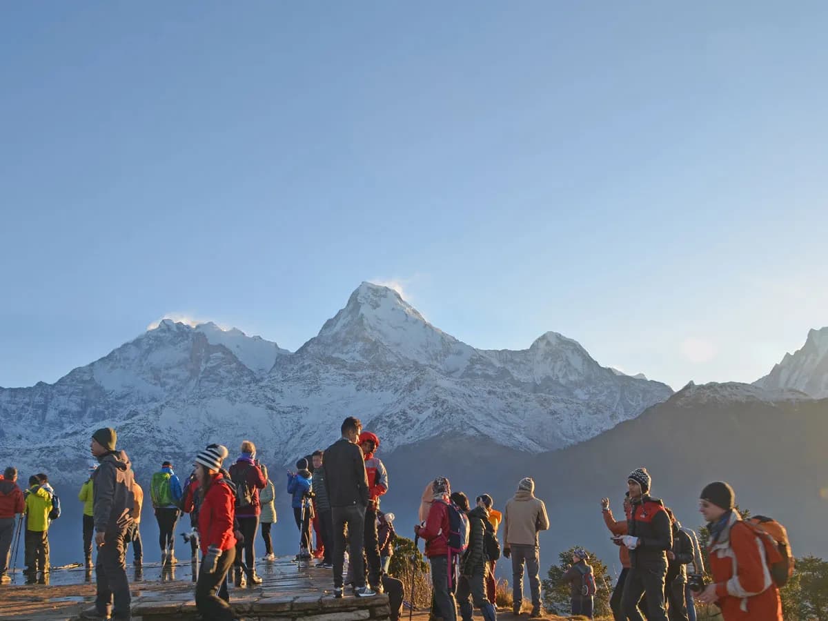 Group of trekkers enjoying sunrise views of the Annapurna mountain range at Poon Hill viewpoint