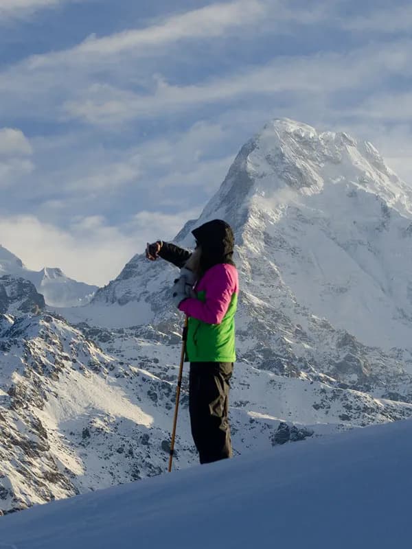 Trekker admiring snow-capped Annapurna mountain peaks from Mulde Viewpoint viewpoint in Nepal