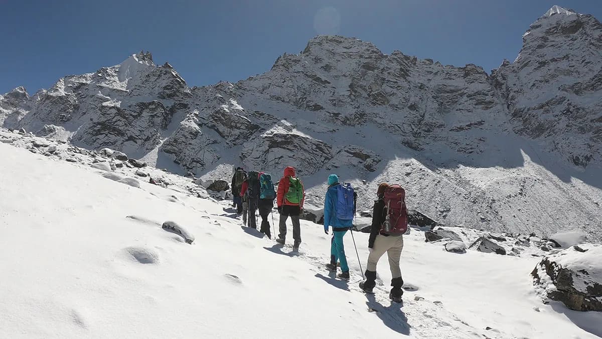 trekkers walking on snowy trail at cho la pass on everest 3 pass trek