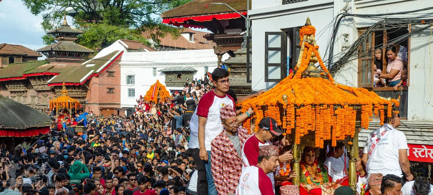 Crowd gathered around golden flower decorated chariot during the Indra Jatra festival procession in Kathmandu