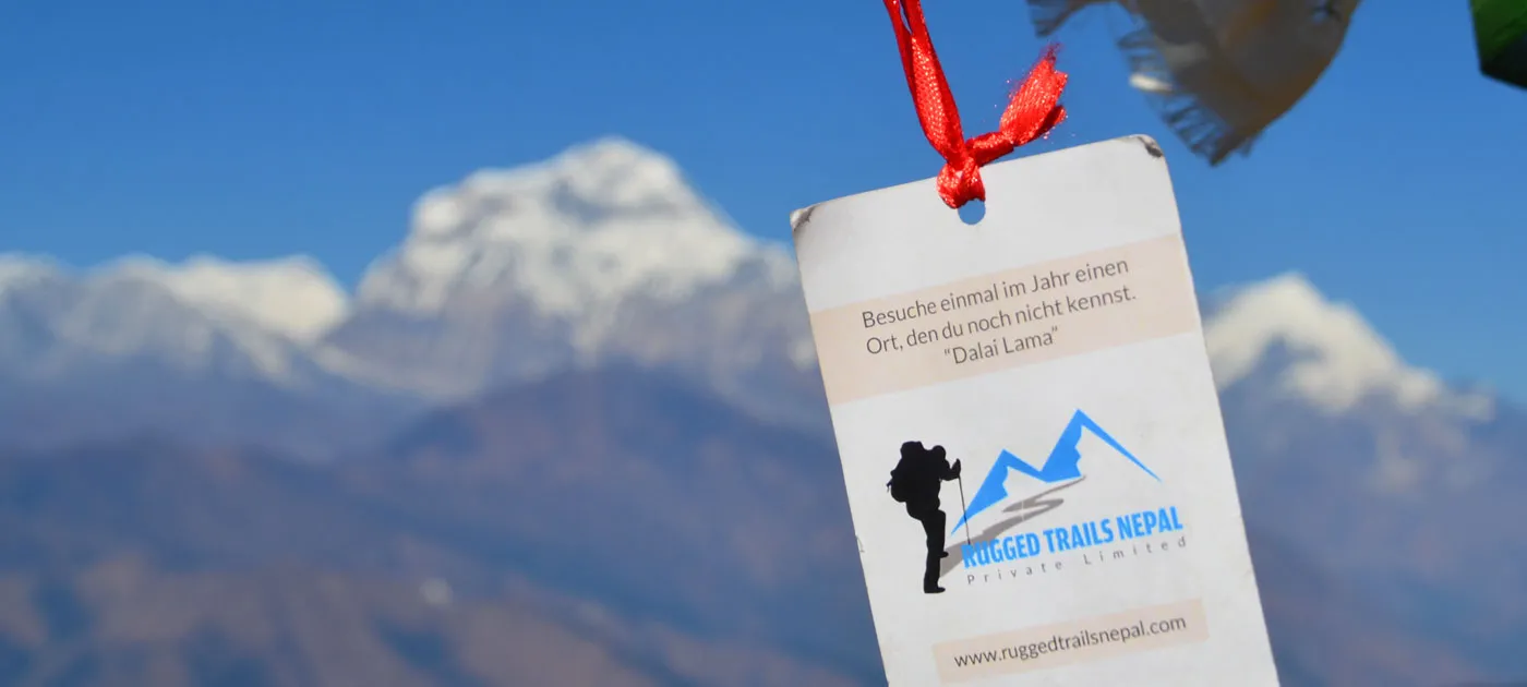 Rugged Trails Nepal informational card featuring a Dalai Lama quote with snow-covered Himalayan peaks blurred in the background.