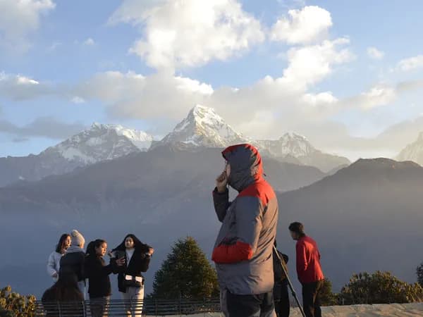 Trekkers enjoying the sunrise view of the Annapurna mountain range from Poon Hill during the Ghorepani Trek