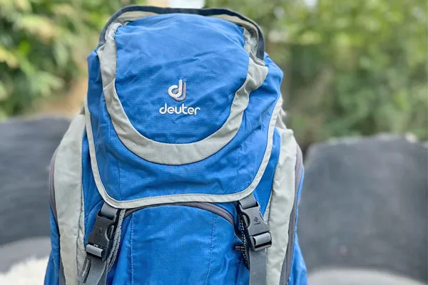 Close-up shot of a blue and grey Deuter trekking backpack packed and ready for a hiking expedition