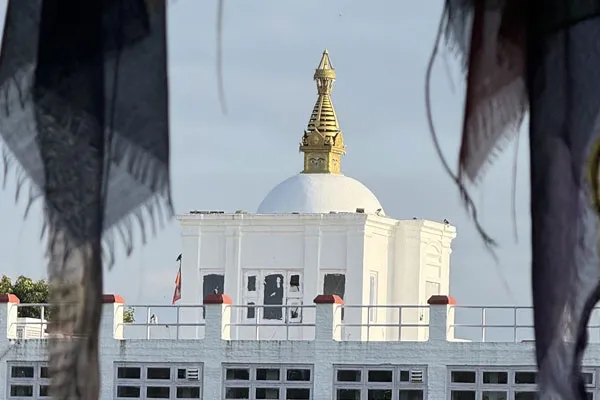 Close-up shot of the golden pinnacle and dome of the Maya Devi Temple in Lumbini, Nepal.