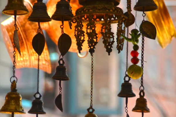 Exploring the bustling streets of Thamel reveals vibrant handicraft shops selling traditional brass bells and souvenir wind chimes.