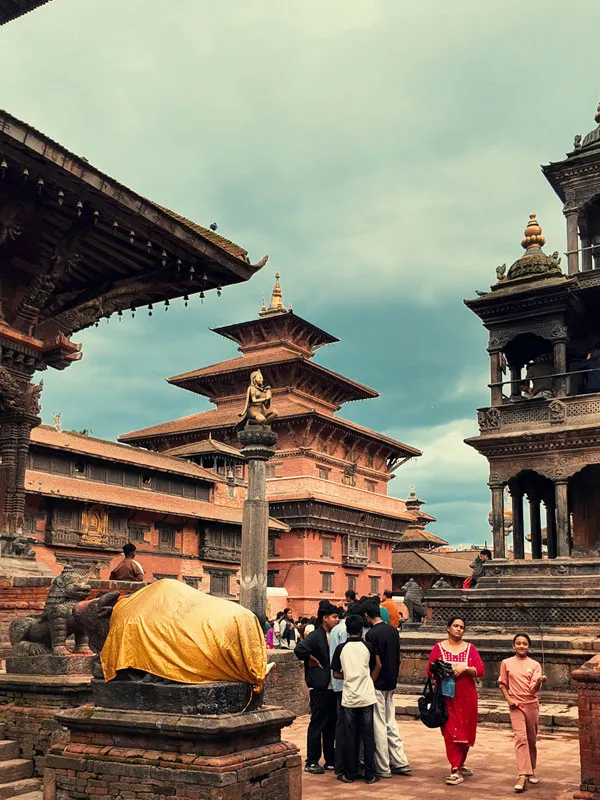 Visitors exploring historic pagoda temples at Patan Durbar Square in Nepal