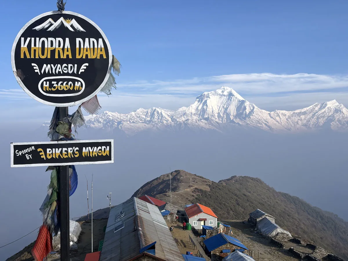Khopra Dada signboard at 3660m elevation with Mount Dhaulagiri in the background.