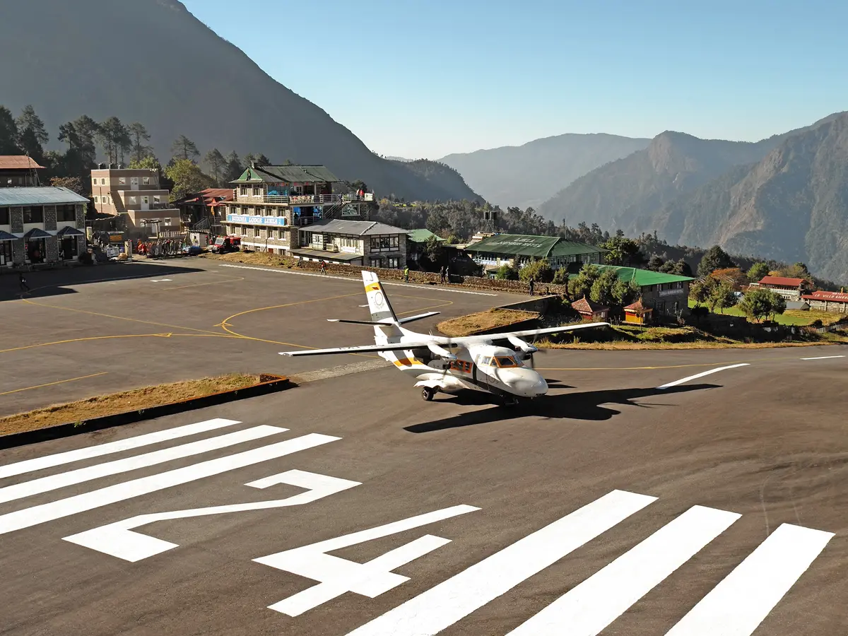 Small twin-otter aircraft on the runway at Tenzing-Hillary Airport in Lukla