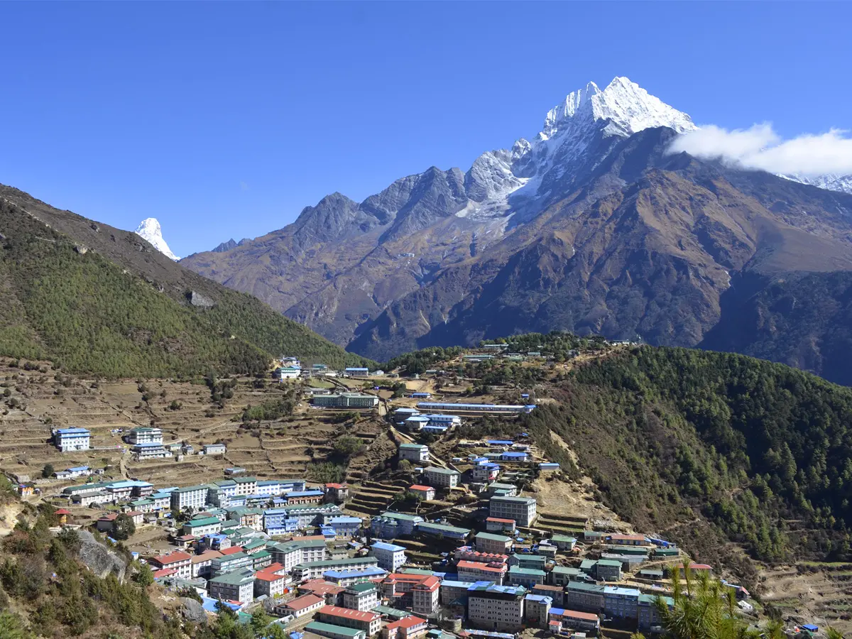 Panoramic aerial view of Namche Bazaar village surrounded by snow-capped Himalayan peaks