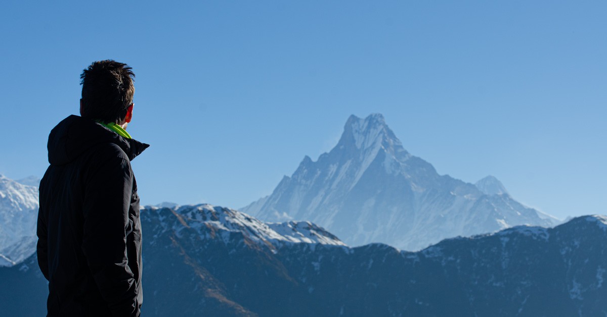 Trekker looking at the iconic Machhapuchhre Mt Fishtail peak
