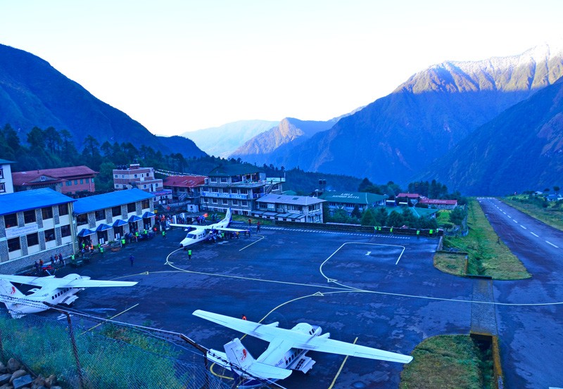 Twin-otter planes parked on the tarmac at Tenzing-Hillary Airport in Lukla