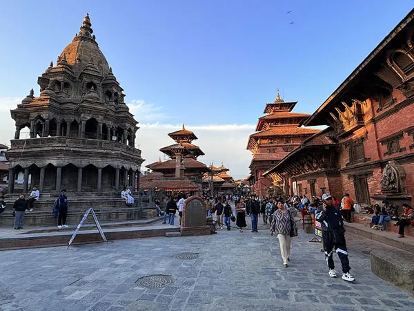 Visitors strolling through the ancient royal complex of Patan Darbar Square in Lalitpur