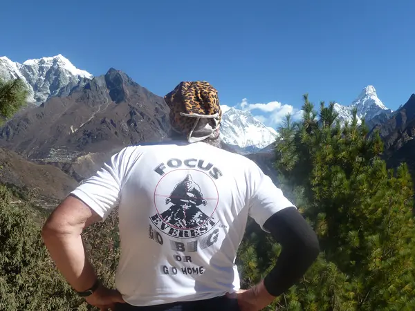 trekker looking towards mount everest from namche