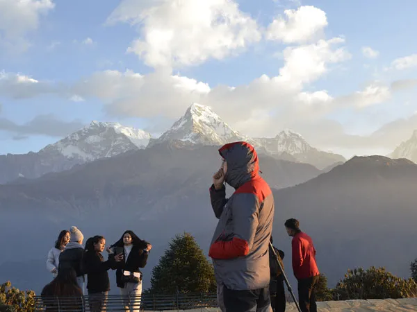 Trekkers enjoying the sunrise view of the Annapurna mountain range from Poon Hill during the Ghorepani Trek