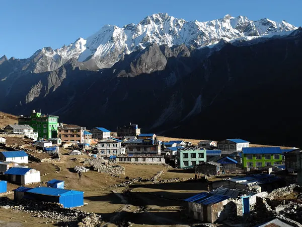 Teahouses and stone buildings of Kyanjin Gompa village nestled beneath dramatic snow-capped peaks on the Langtang Gosaikunda Helambu Trek in Nepal.