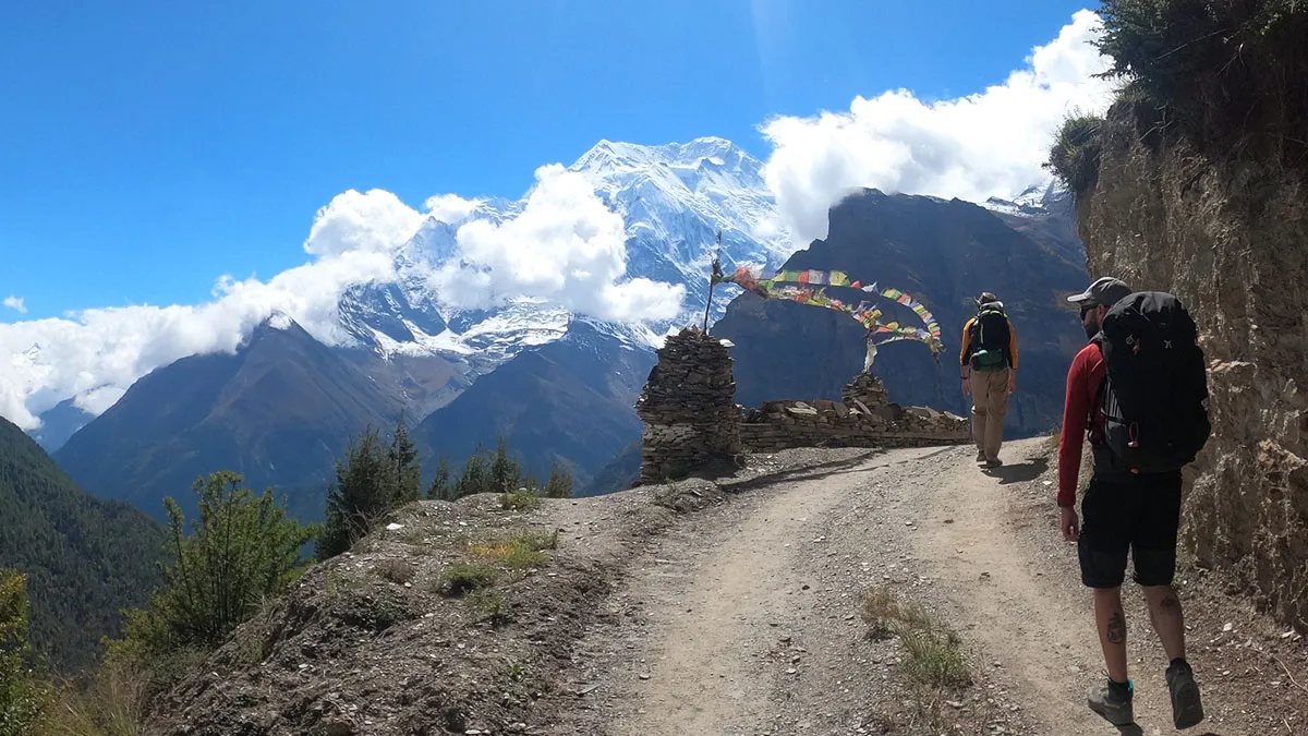 trekkers walking in annapurna circuit trekking route with mountain view infront